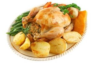 Whole roast chicken with potatoes pumkin carrots and beans.